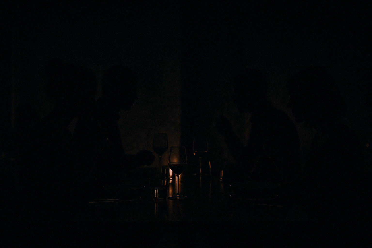 silhouette of diners in a dark restaurant - unique dining spots